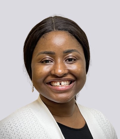 Abidemi Daniyan, Board member, smiling in a professional headshot wearing a white cardigan over a black top.