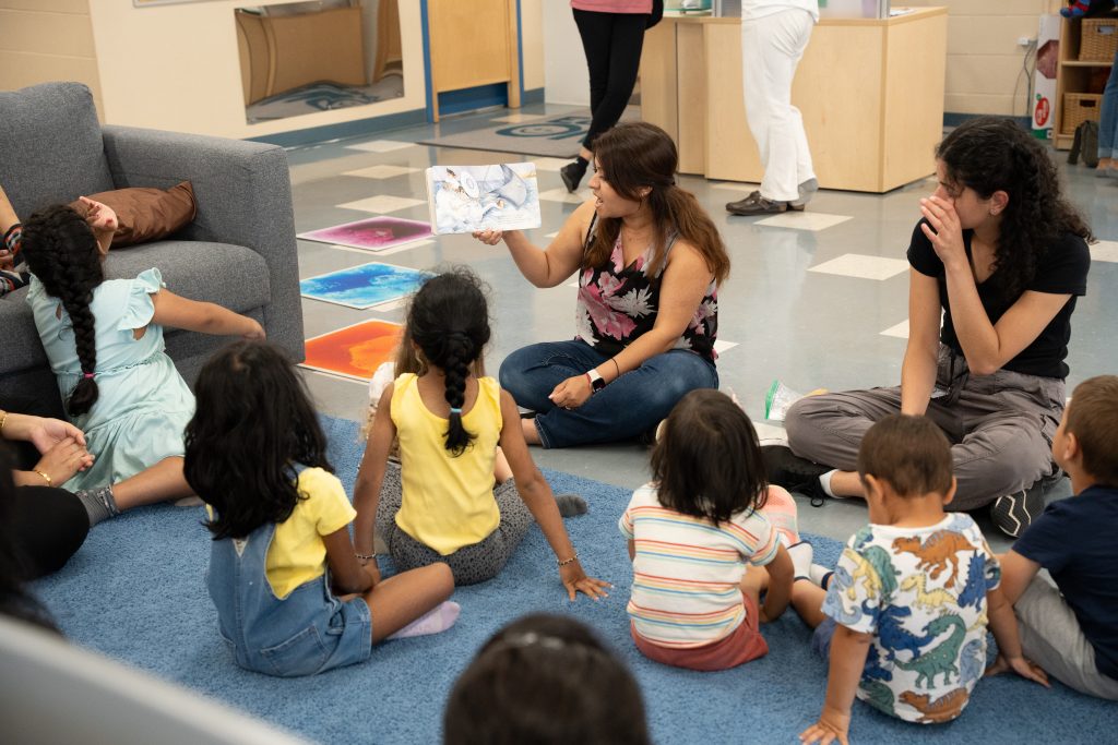 Families gathered together to hear a story at BrightStart