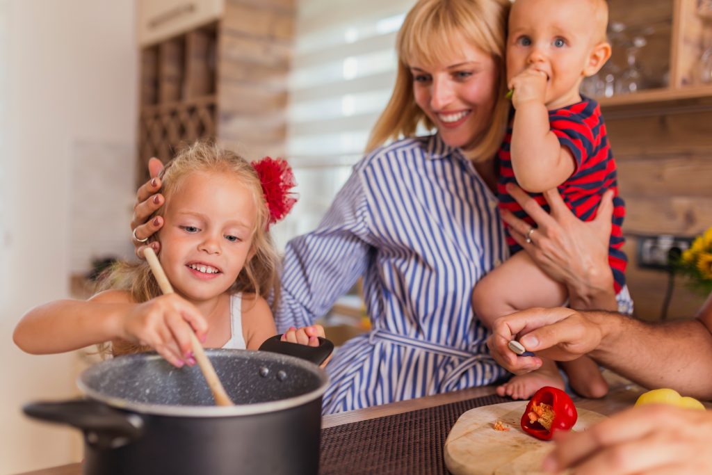 A young family cooking together in a kitchen